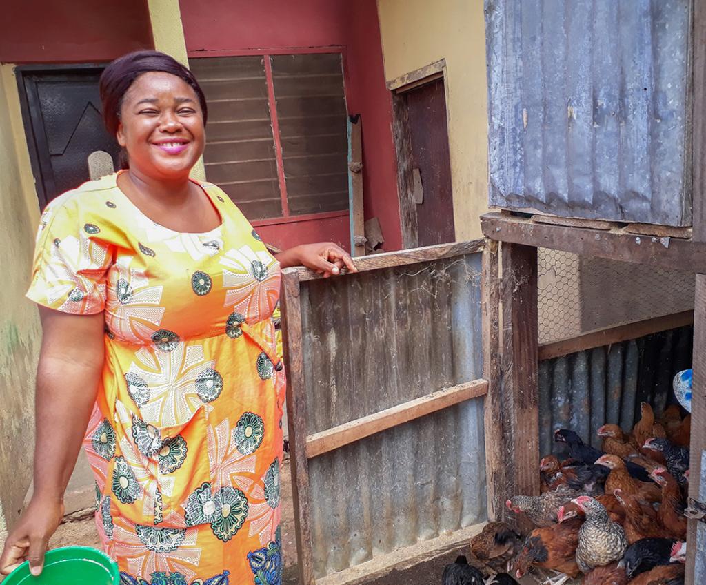 Sewuse standing by her birds