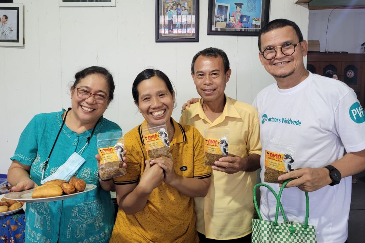 Pastors Mody and Nyami hold their dried catfish product