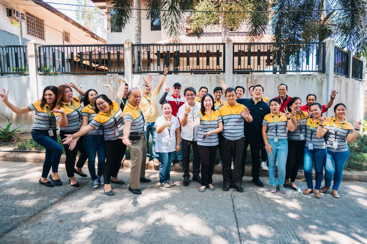 a group of employees pick fun poses for a picture