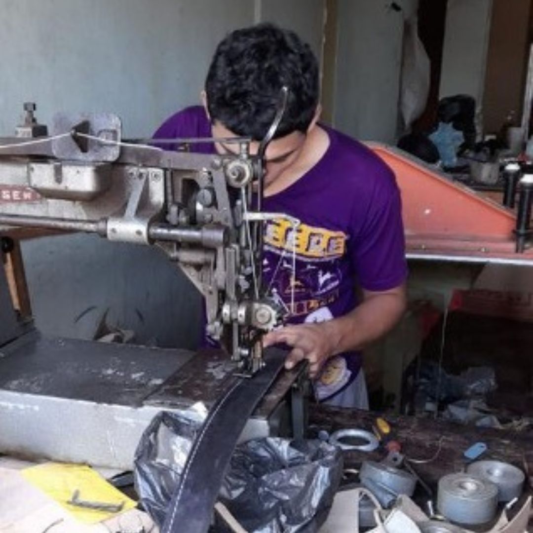 a man works at an industrial sewing machine