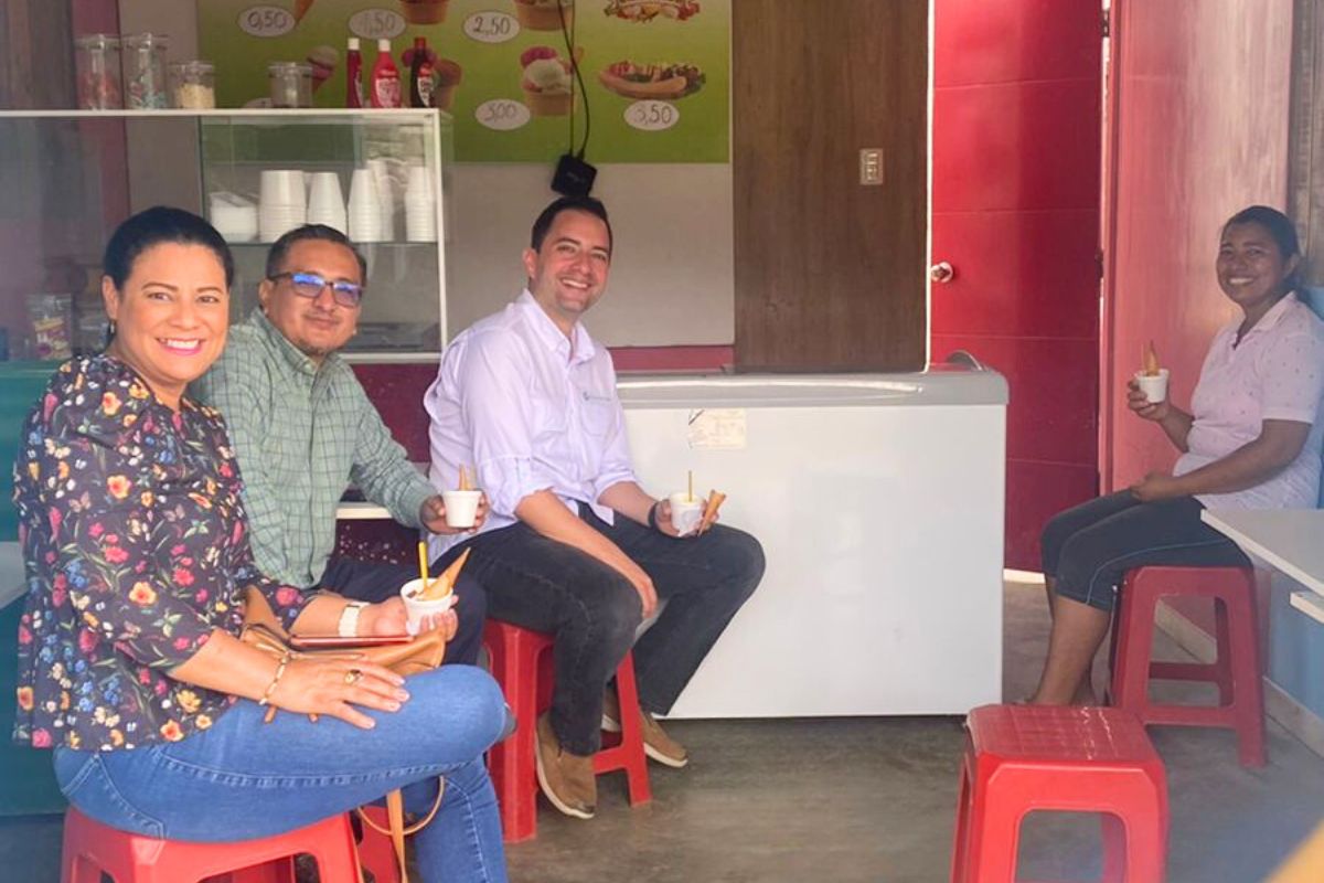 people sit in a small business lobby eating ice cream