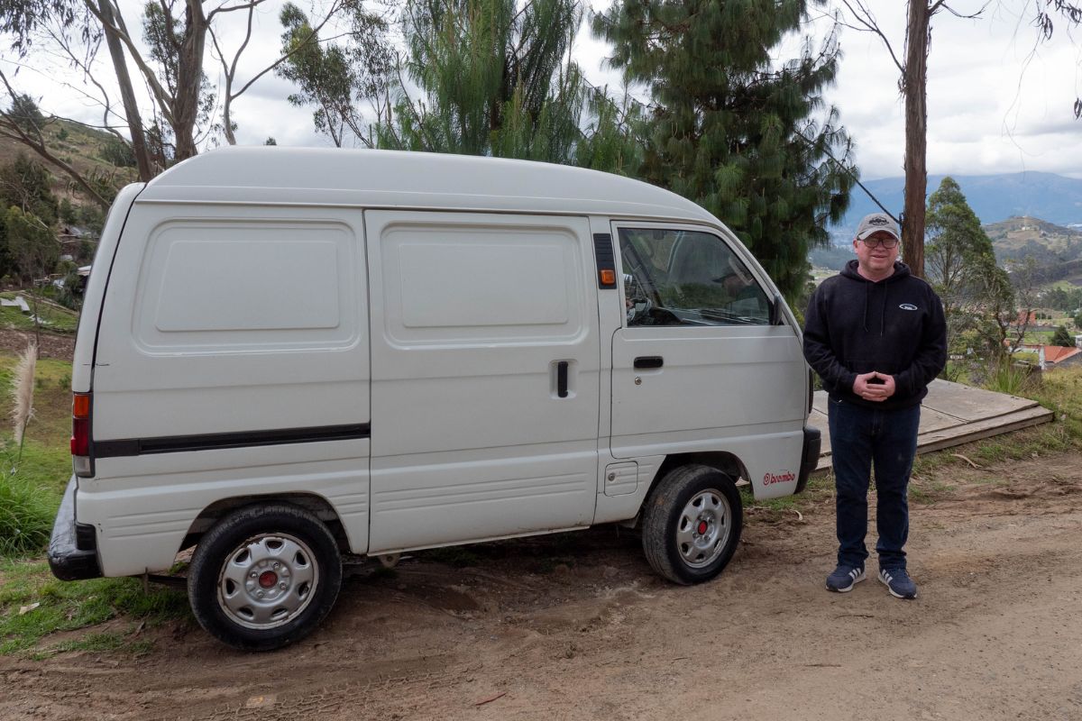 Marco stands next to his van