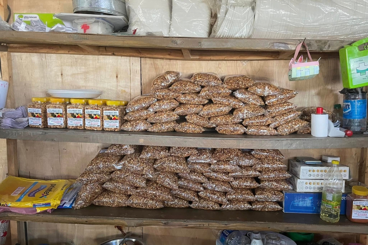 bags of nut and seed snack mixes sit on wooden shelves
