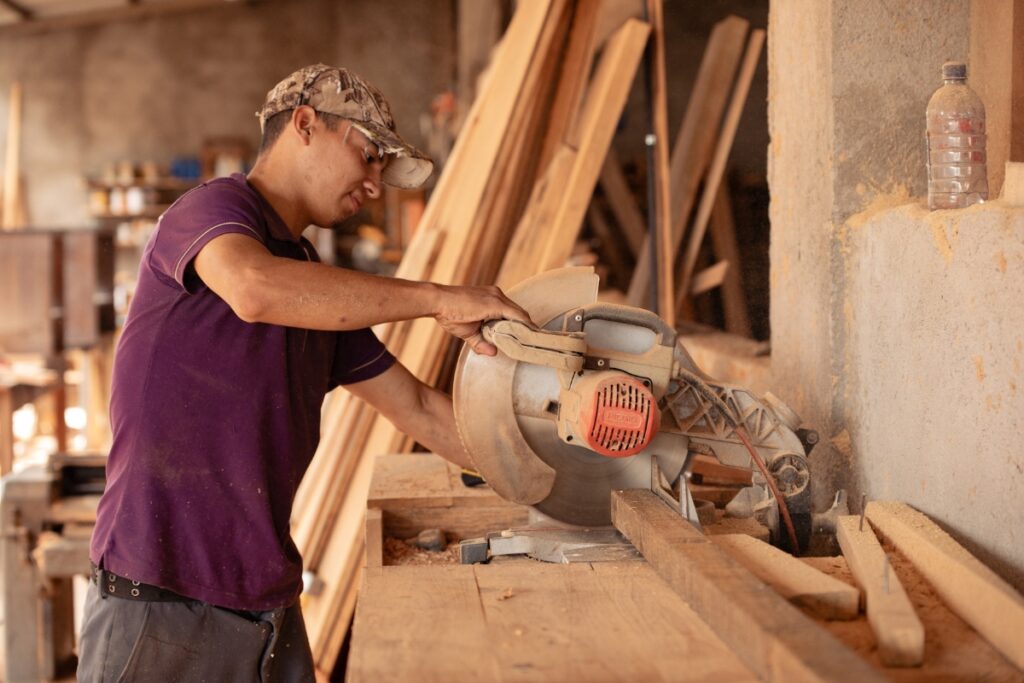 a man works at a saw in a workshop