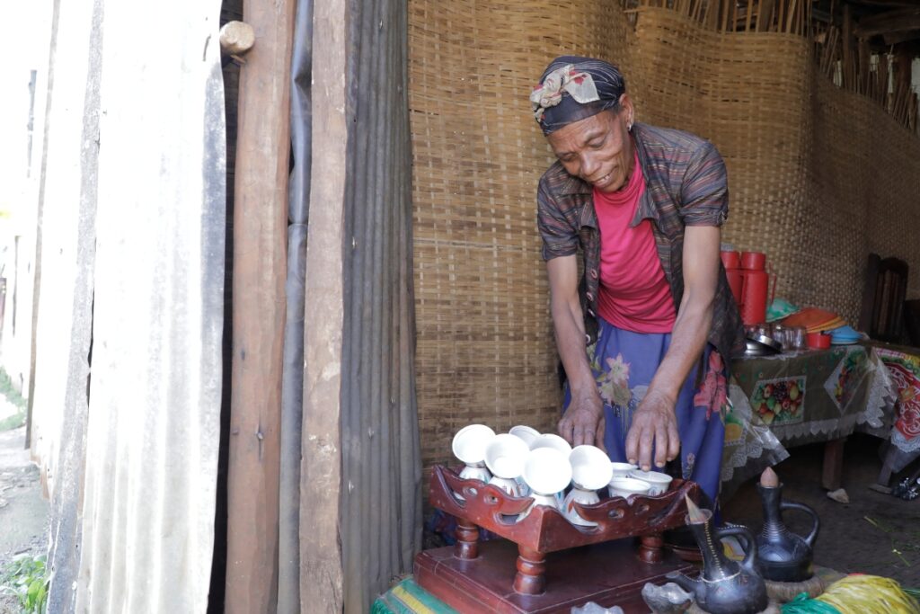 a woman stacks white coffee cups