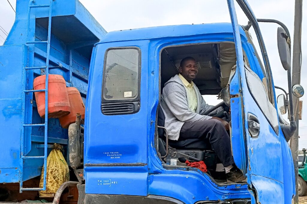 a man sits in the driver's seat of an industrial truck