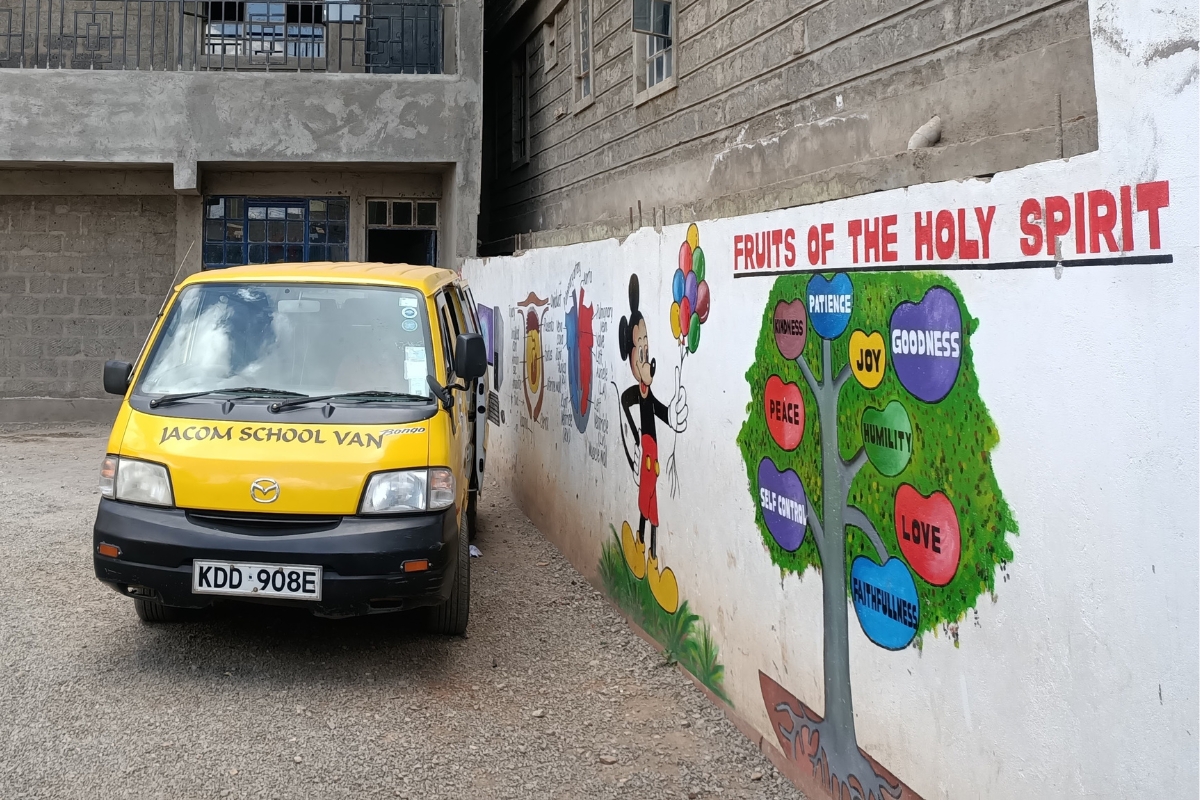 a yellow van is next to a wall with a mural of a tree and the words "fruits of the Holy Spirit"