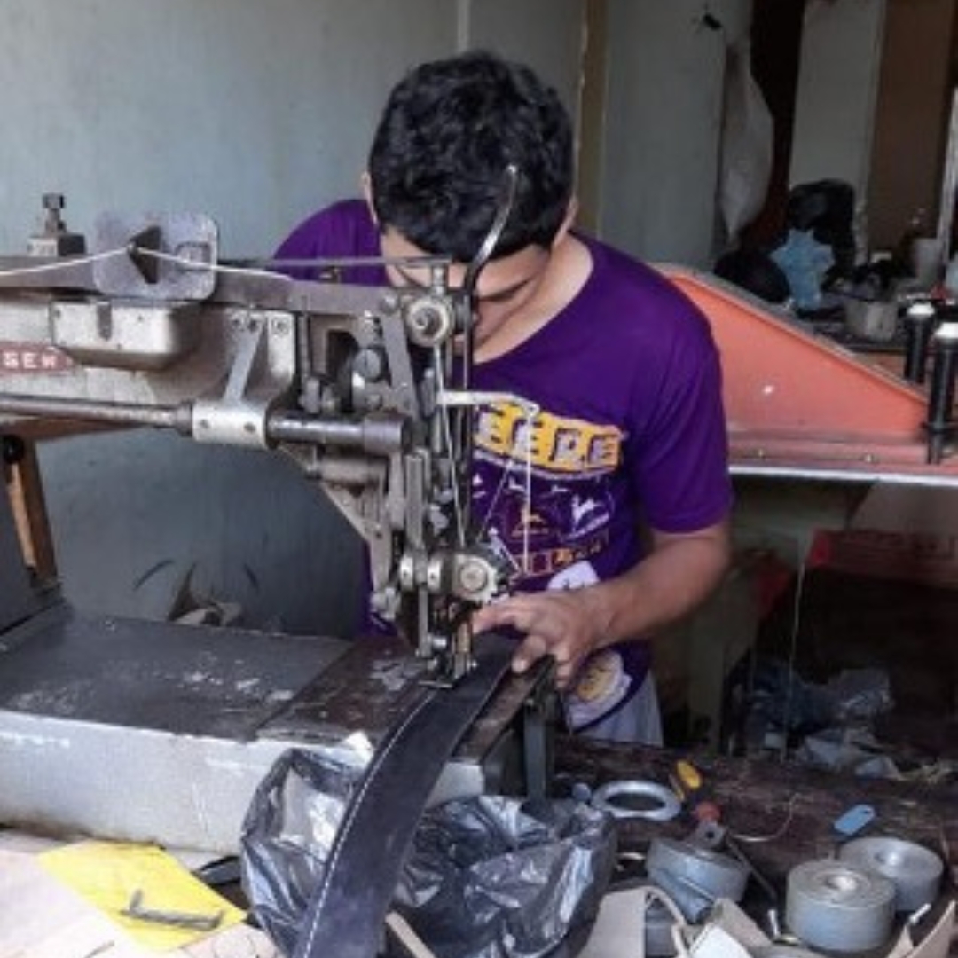 a man sews at a sewing machine