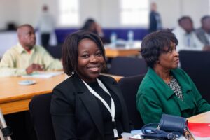 two women sit at a desk