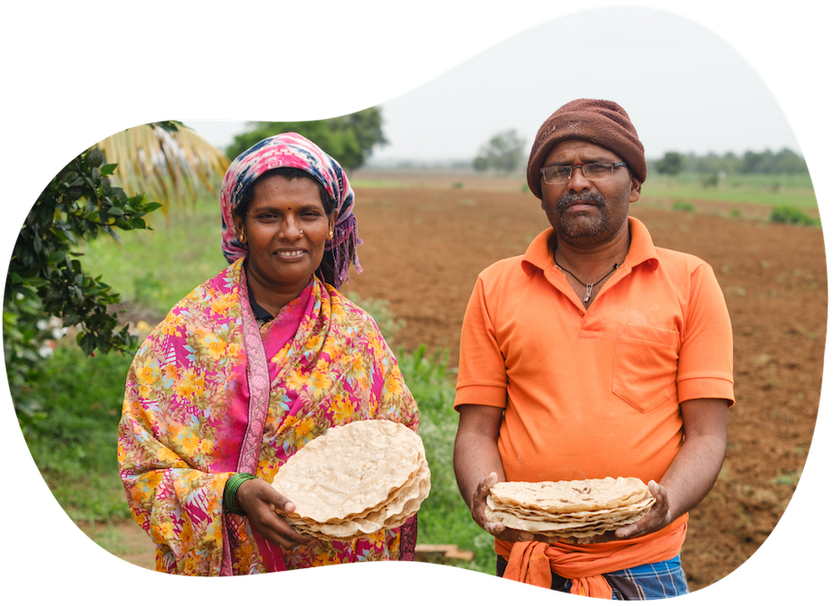 a woman and a man hold roti