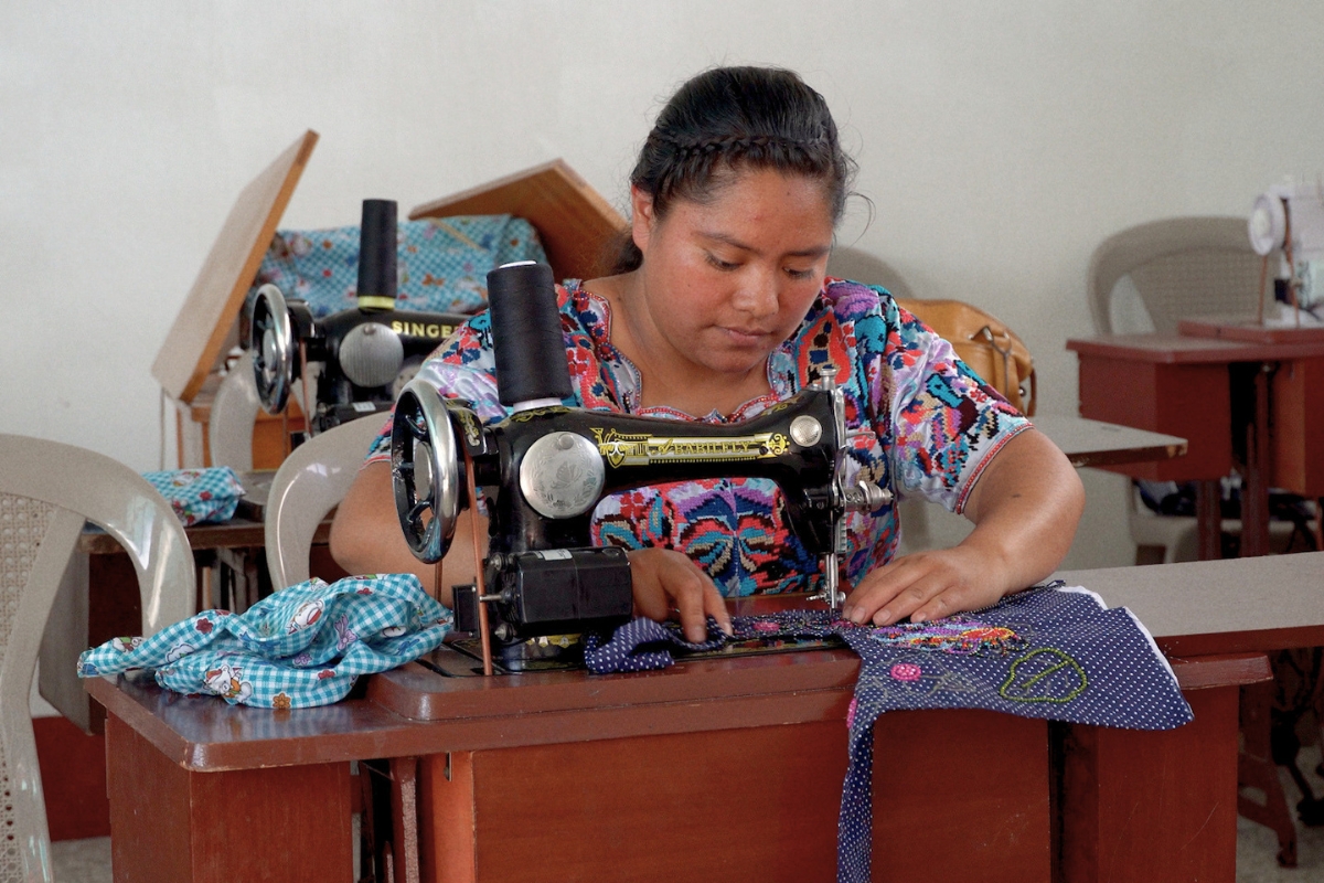 a woman sews with a sewing machine