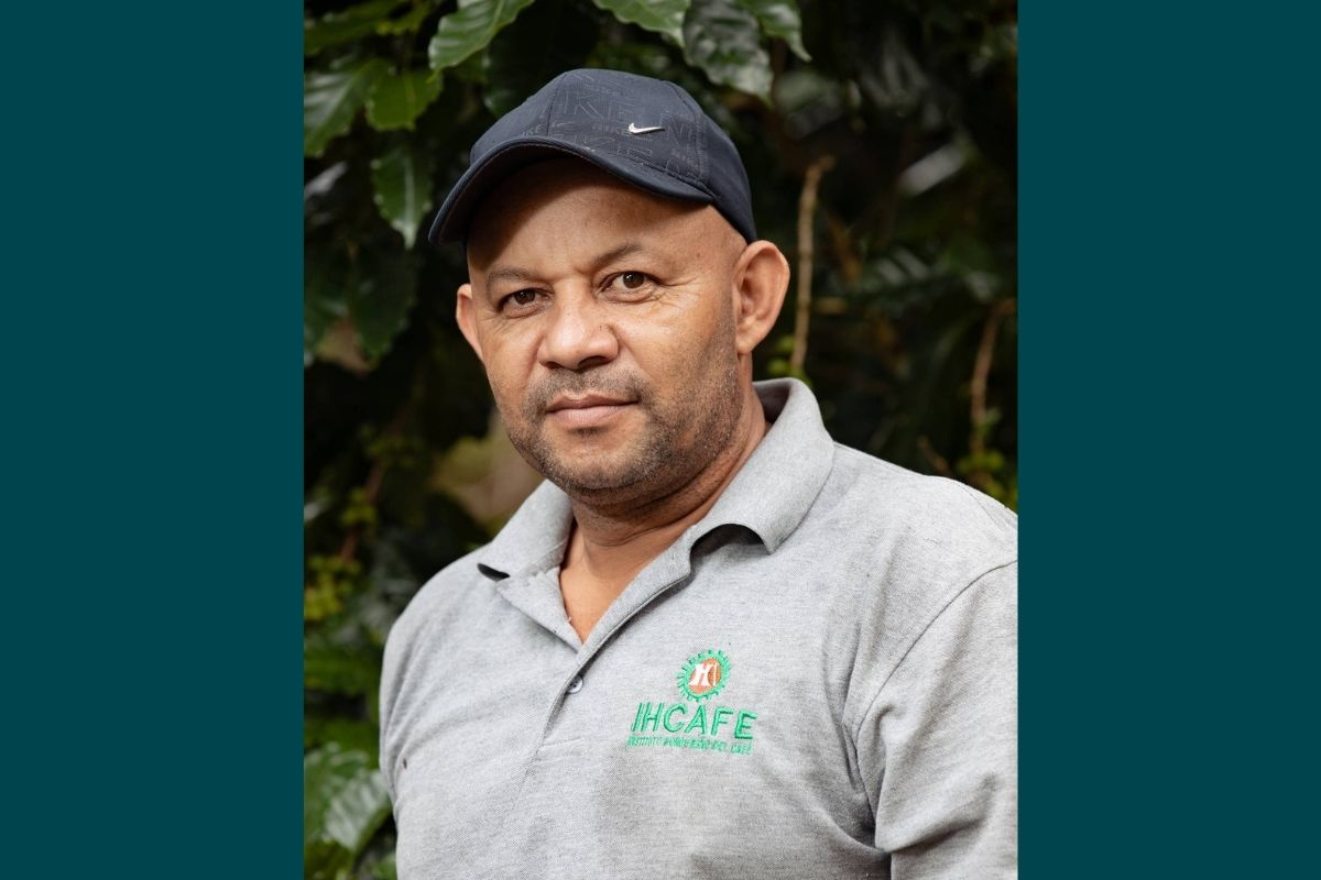 man wearing a hat and grey polo